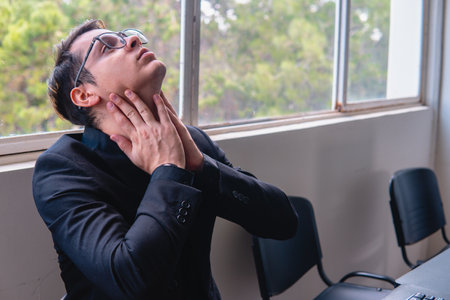 Office worker stretching after a long day at work. High quality photoの写真素材