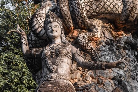 half Woman and snake statue name as Nakee at Sala Kaew ku(sculpture park) in Nong Khai Province Thailandの写真素材
