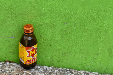 April 25,2020 A bottle of Energy drink M150 brand was on the floor with green background at Huykwang market ,Bangkok Thailandのeditorial素材