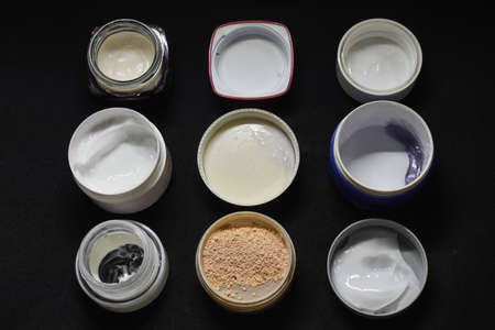 Top view of various facial cream and powder with black backgroundの写真素材