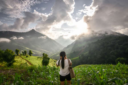 September 9,2018 Backside of Asian girl with Gucci handbag taked the photo of landscape morning view of Doi Phu Kha National park at Nan Province Thailandのeditorial素材