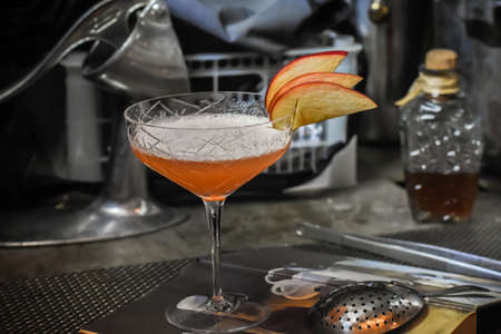 Signature cocktail decorated with red appleの写真素材