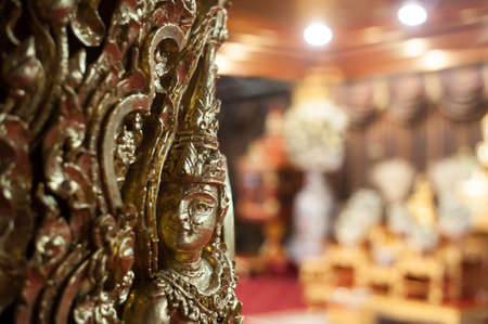 Closeup  face of golden buddhist Angel at the pole in Pagoda at Wat Paknam temple in Bangkok Thailandの写真素材