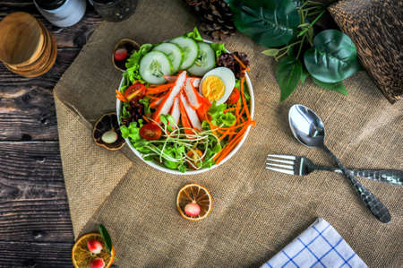 Top view of classic thai green salad that including various vegetable, boiled egg, and crab sticksの写真素材