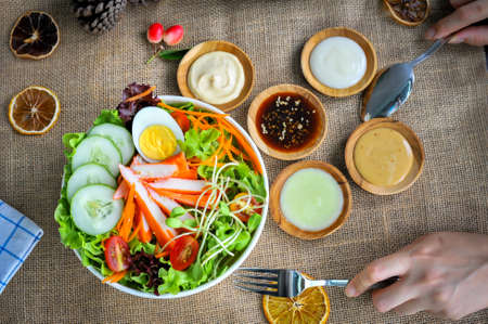 Top view food of  class garden salad that including boiled egg,vegetables ,crab sticks and variety...