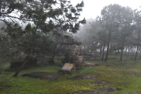 The Rock with a signboard in Thai word (The Rock of Shiva God) at Phu Ruea National Park on raining day, Loei province Thailandの写真素材