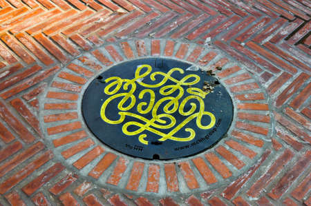 October 14,2020 The graphic manhole cover with thai word Sawatdee (Hello) from mchhgroup company at Saphan han (Street art) in Bangkok Thailandのeditorial素材