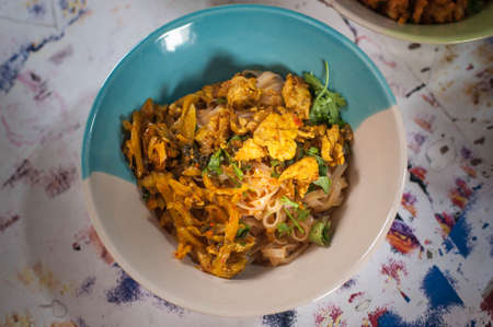 Top view  of Burmese style chicken dry noodle or in thai name dry Khao soi at Phahurat market (The indian town ) in Bangkok Thailandの写真素材
