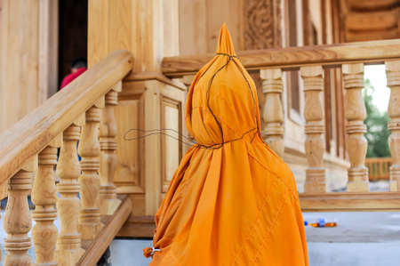 The yellow robe of Buddhist monk wrapped the Buddha statue at Wat Khun Samut Chin temple in Samut Prakan province,Thailandの写真素材