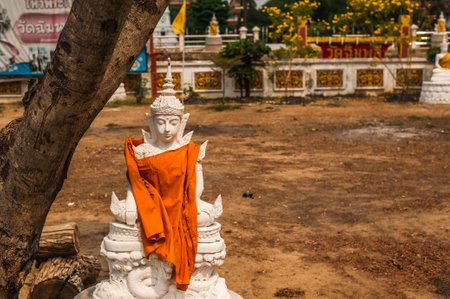 The White buddha statue with yellow robe at Wat 
Wat Chimphli Sutthawat at Ko Kret Island ,Nonthaburi province ,Thailandの写真素材