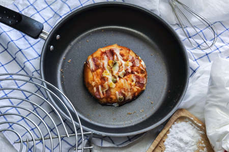 Top view of homemade pan-fried bacon and ham mini pizza in Bangkok, Thailandの写真素材