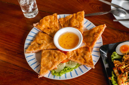 Crispy spring roll stuffed with prawns and pork with plum sauce or in thai name Goong Gra Buangの写真素材