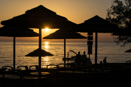 beautiful ocean sunset with silhouttesの写真素材