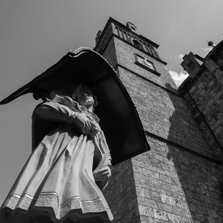 angel statue in front of churchの写真素材