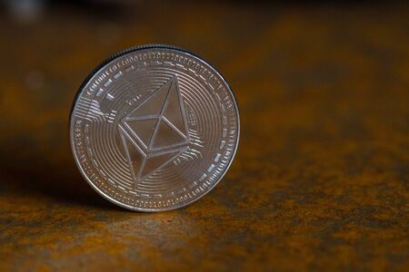 silver ethereum coin close-up with rusty backgroundの写真素材