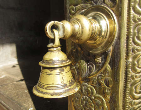 Bell on a temple door in an indian temple.の写真素材