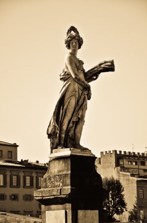 view of the statue of the summer on the holy trinity bridge in Florenceの写真素材