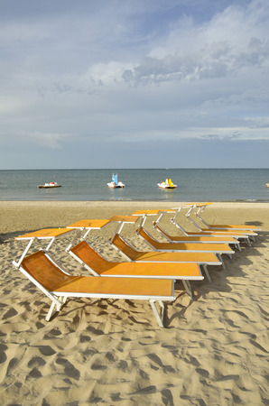 The splendid symmetry of deck chairs on the beautiful beach of Cerviaの写真素材