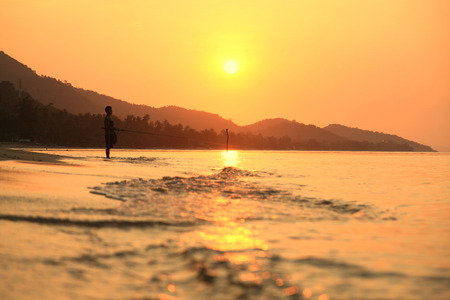 The siluette of single fishermanの写真素材