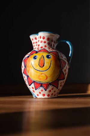 Ceramic beautiful painted vase with handle and sun motive onの写真素材