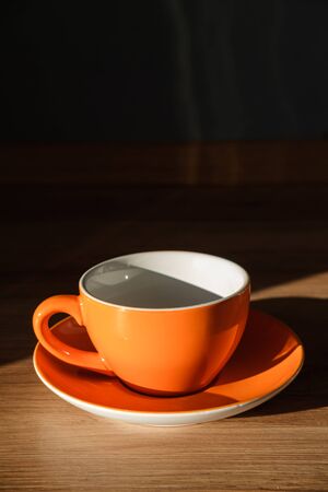 Tea and coffee Cup and plate orange and white colourの写真素材