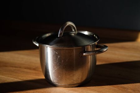 Metal stainless steel pot with a lid onの写真素材