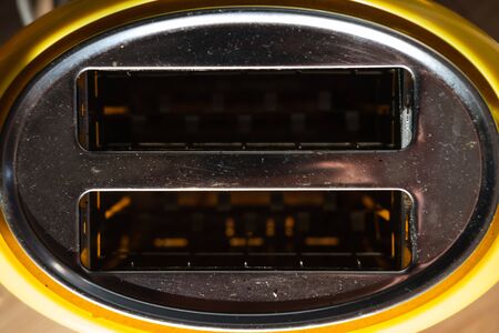 Yellow and white plastic toaster with stainless steel topの写真素材