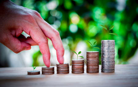 Male hand stack coins same stair for the first step like growing for the future, education, home,...