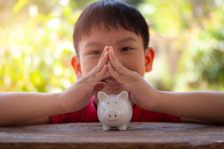 Young boy make hands look like a house to show concept new house, saving money,protect money, plan...