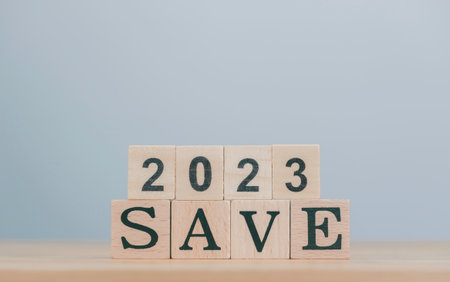 Budget planning for new year 2023 and changes the inscription "SAVE 2023", business, finance, investment and allocation concept on grey background, copy space. Useful for banner and presentation.の写真素材