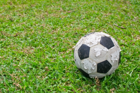 Old soccer ball on the green grassの写真素材