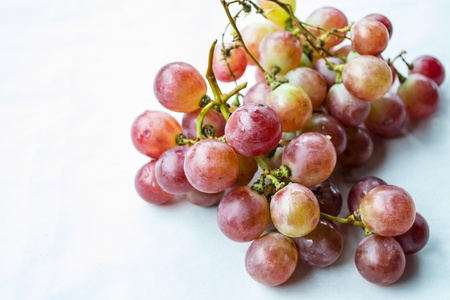 Red grapes on a white backgroundの写真素材