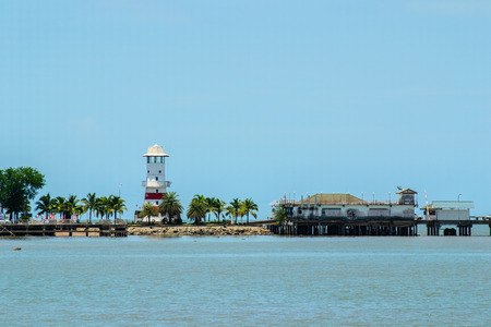 White lighthouse with the sky and the seaの写真素材