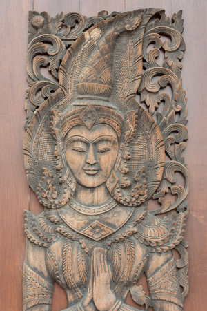 Wood carved scroll Vow wooden door in templeの写真素材