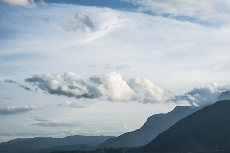 Storm clouds with rain along the mountain range.の写真素材