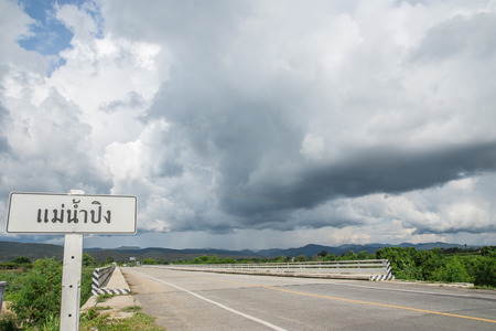 The bridge of the river  Ping with rain clouds.の写真素材