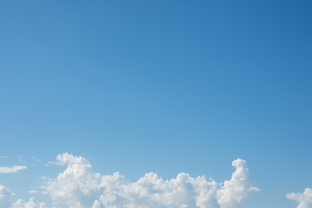 Bright blue sky with white clouds.の写真素材