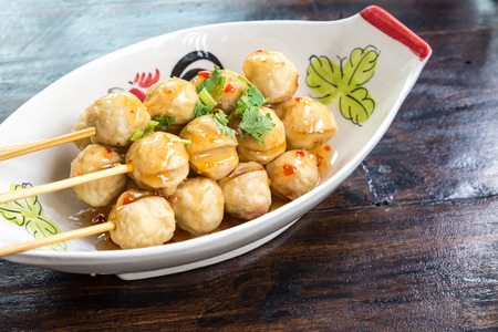 Meatball skewers topped with a spicy sweet sauce.の写真素材