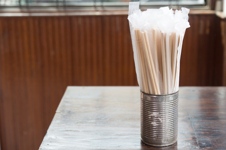 Wooden chopsticks wrapped with plastic tableware.の写真素材