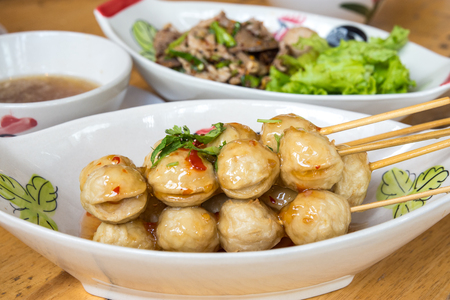 Meatball skewers topped with a spicy sweet sauce.の写真素材