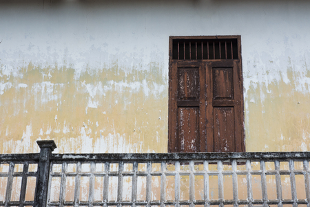Ancient brown wall with windows and balcony railings.の写真素材