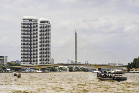 Boat hire across the Chao Phraya River at Somdet Phra Pinklao Bridge in late July 2017 in Bangkok, Thailand.のeditorial素材