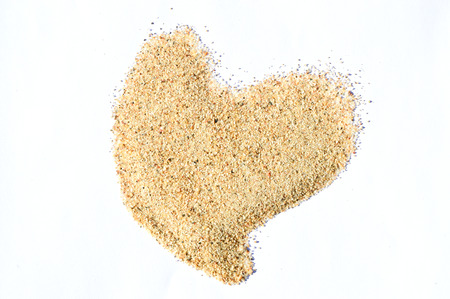 pile desert sand isolated on white background, fine sand  texture. heart shapeの写真素材