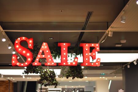 Sale text lighted with bulbs at department storeの写真素材