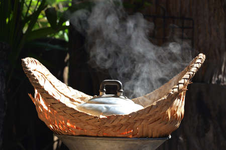 Steam heat from traditional Thai cooking with bamboo weaveの写真素材