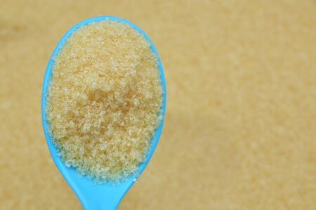 Brown sugar in spoon with sugars backgroundの写真素材