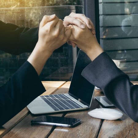 Successful business partner giving hand promise at meetingの写真素材