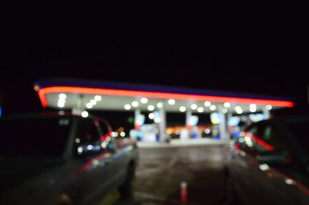 Absract blurred petrol gas station in night background with light bokehの写真素材