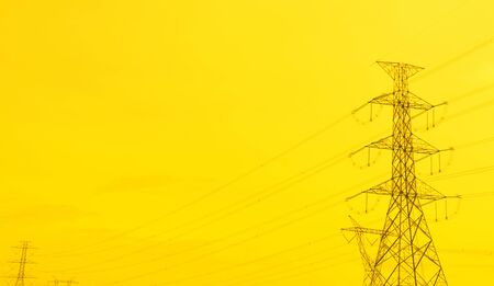 A high voltage post with golden sky. Prosperity to the city. Public utility or infrastructure.