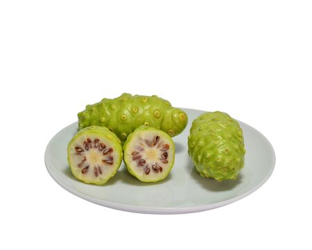 Noni Indian Mulberry fruit on white dish. white backgroundの写真素材